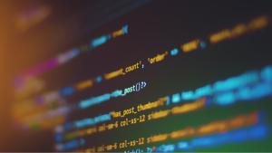 an image of multicolored computer code in orange and light blue, on a black background