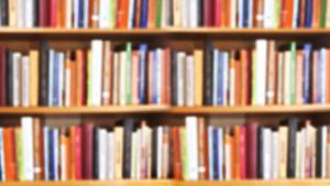 Book shelf with stacks of books