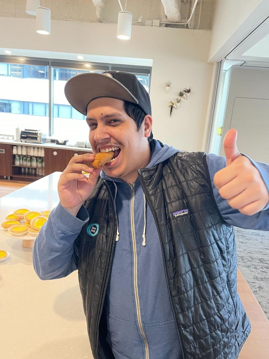 A Relic eating lumpia, a Filipino egg roll.