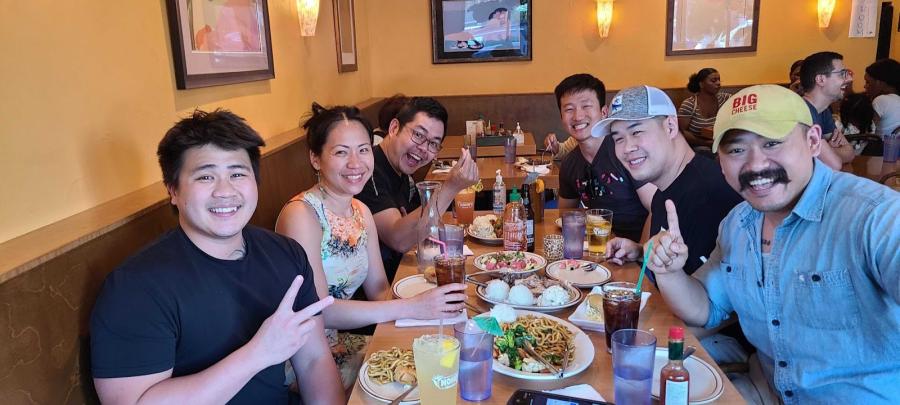 A group of Relics eating Hawaiian-style family dinner.