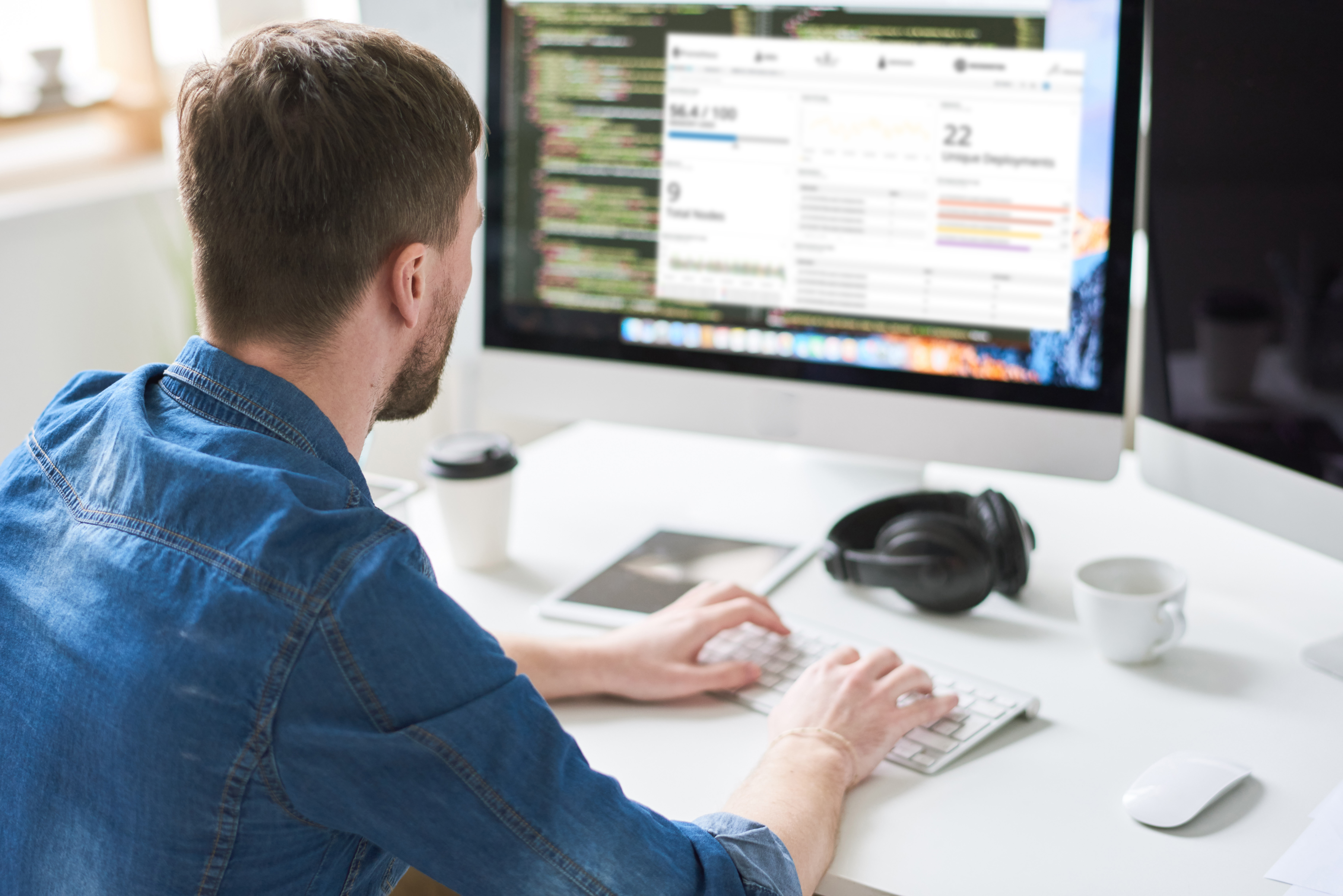 User sitting in front of a New Relic Dashboard