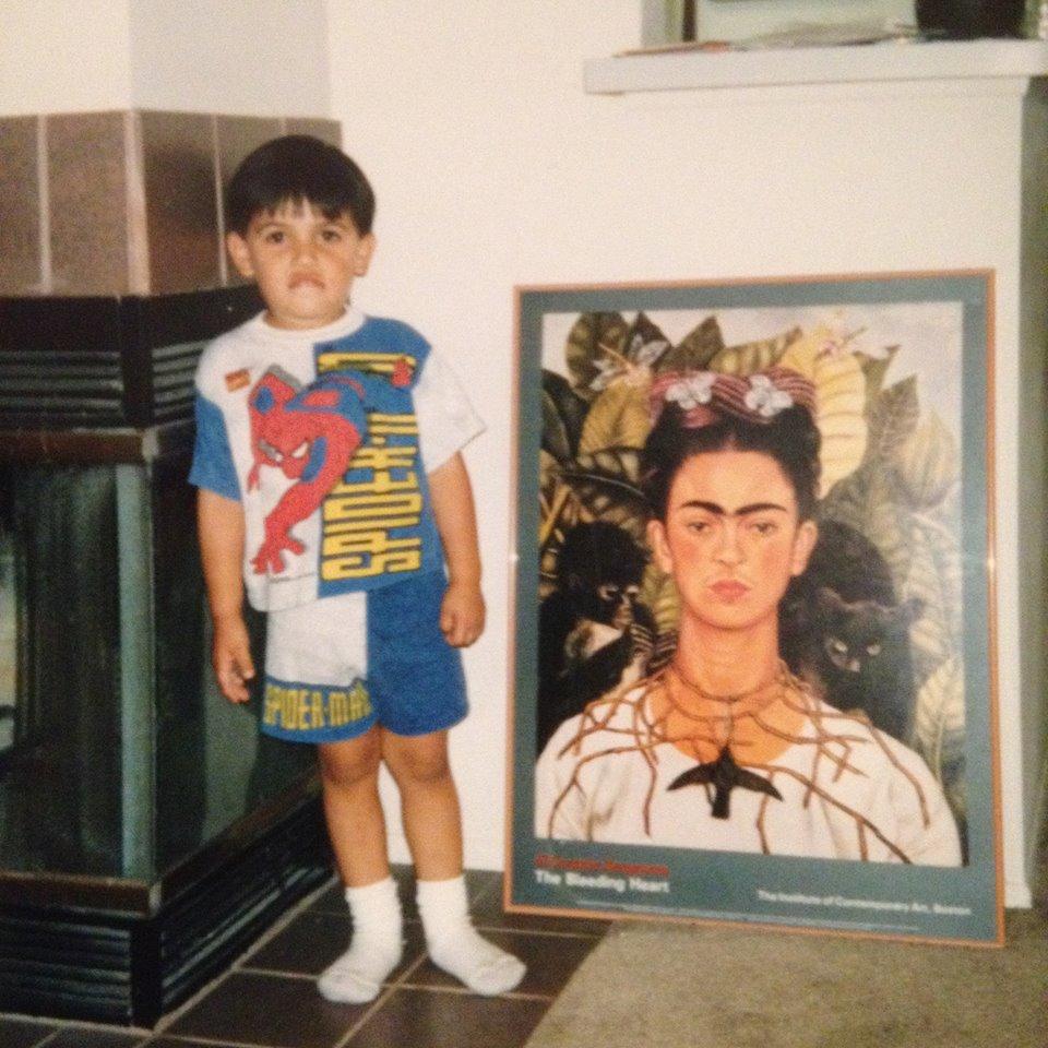 Danny Ramos as a child with a portrait of Frida Kahlo.