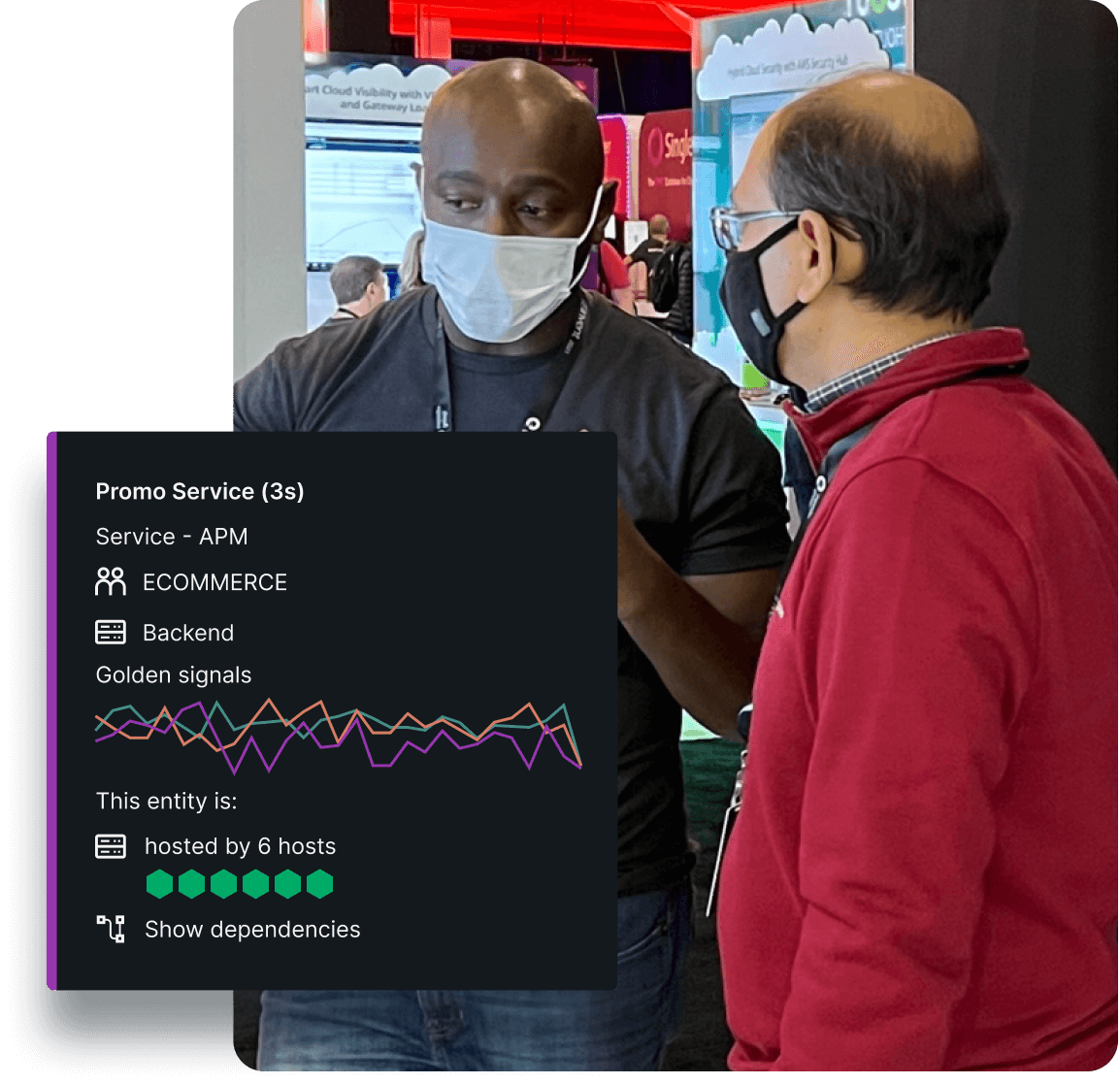 Two people conversing at reinvent with a New Relic AWS monitoring dashboard