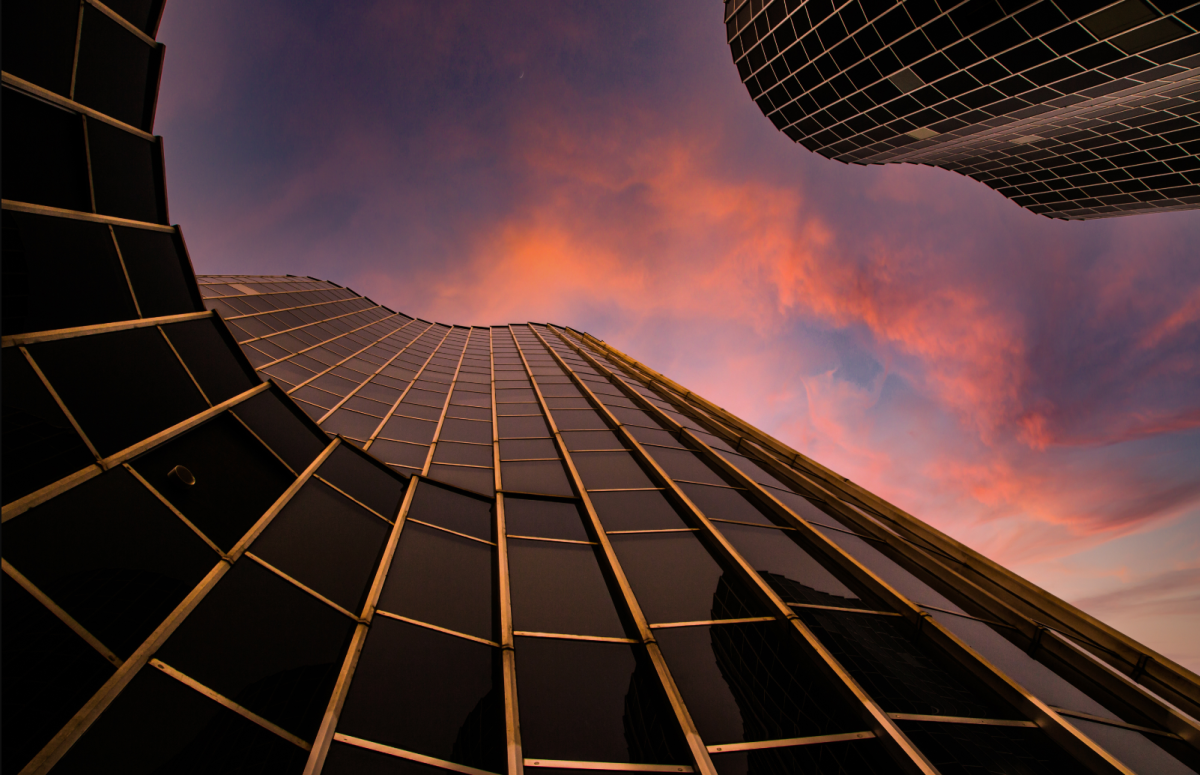 Looking up a skyscraper at clouds