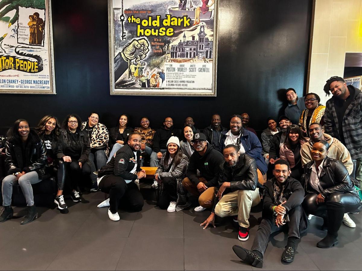 Group photo in front of old movie poster