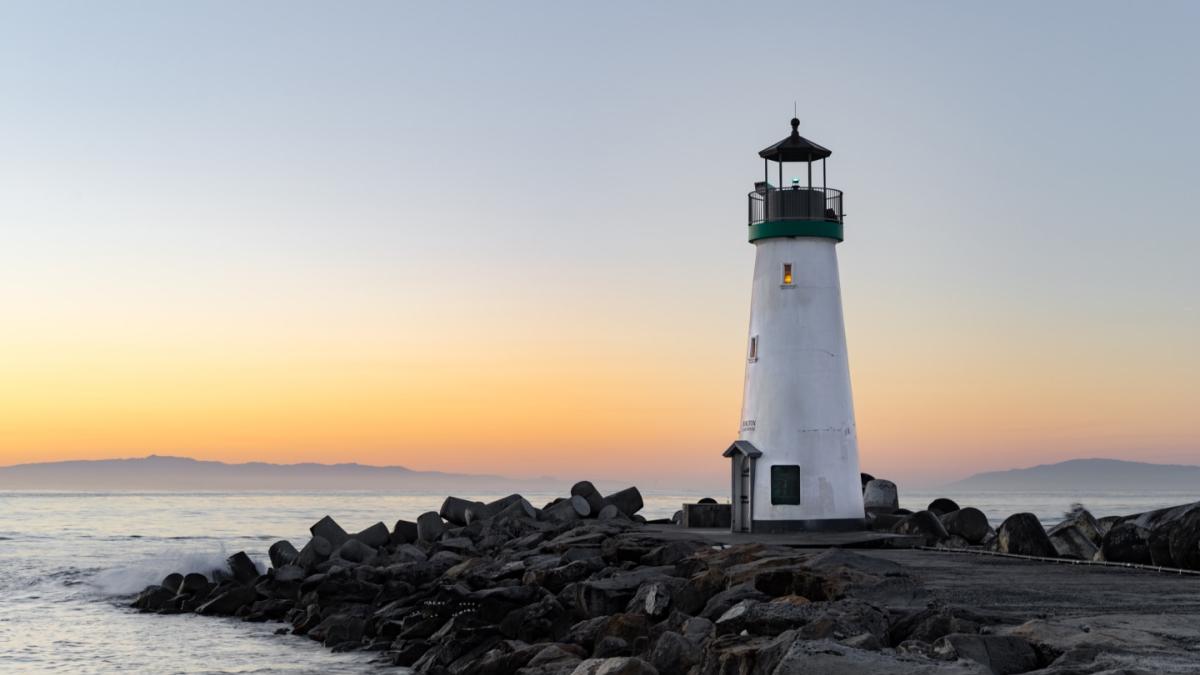 Image of lighthouse on rocky outcrop of coast