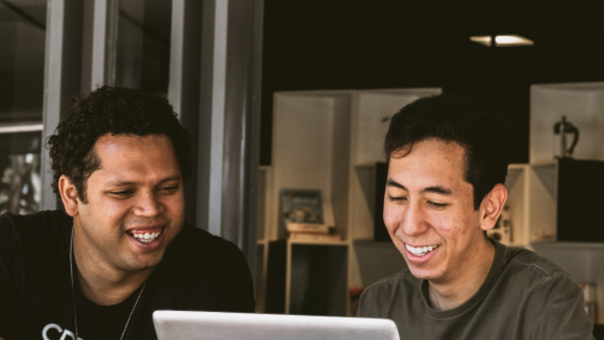 Two people working at a laptop together