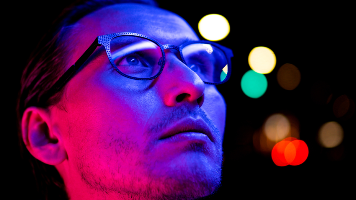 Man with glasses looking up