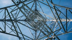a photo looking upwards inside a steel structure with multiple rods and beams in a diamond formation 