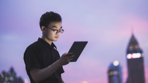 Developer watching a tablet computer in a city