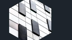 Photo of black panels on a building, viewed through a hexagon