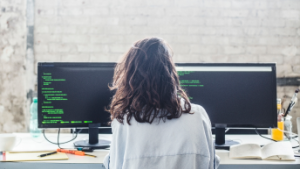 Individual sitting in a chair working on their desktop