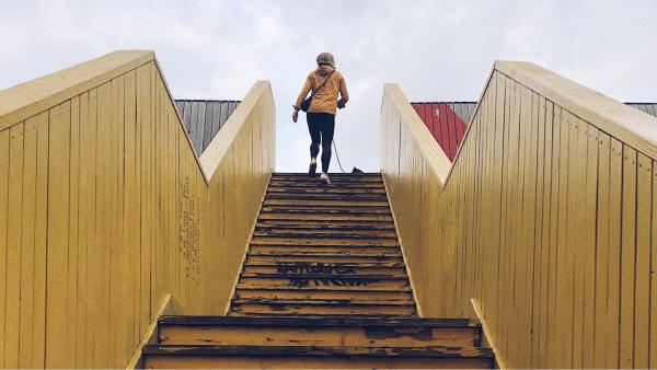 A runner going up a set of wooden stairs