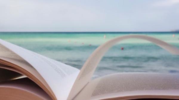 Book open with ocean in background