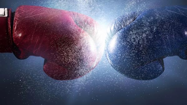 Two boxing gloves colliding
