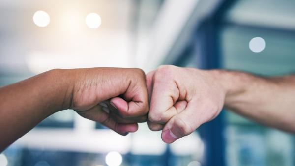 Conceptual iStock-1081960210.jpg Two hands in a fistbump position