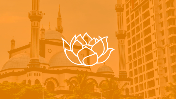 White lotus icon over a orange tinted photo of a building Bangalore, India