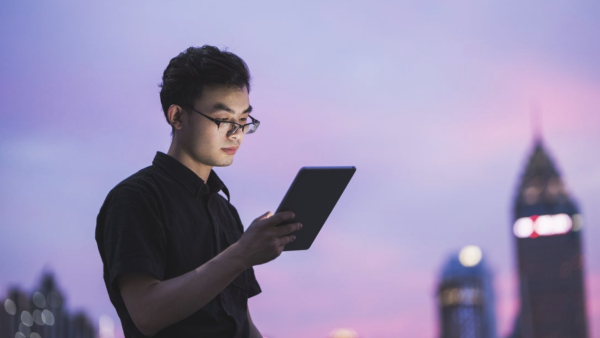 Developer watching a tablet computer in a city