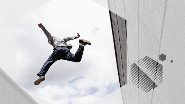 Man leaping from one building to another