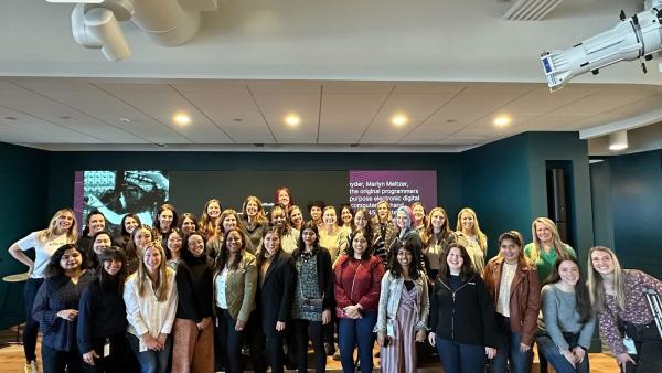 A group of Relics gathered in an office to celebrate Women's History Month