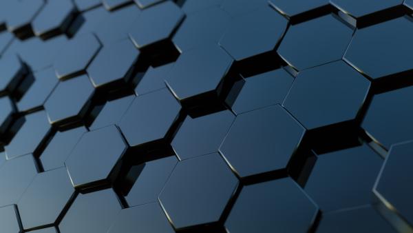 Image of stacked rows of black, shiny, 3-D hexagons