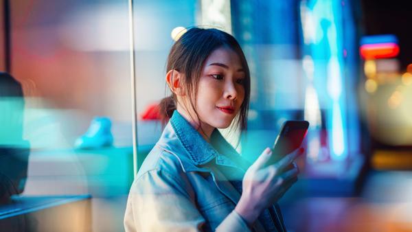 Person looks at phone in a street