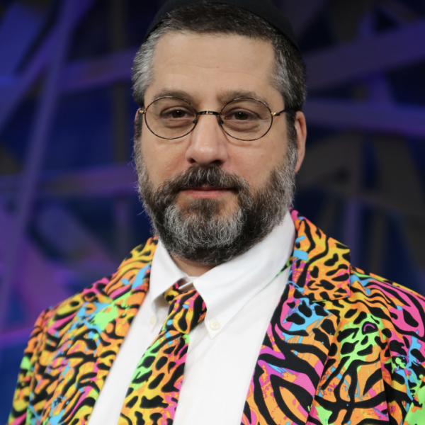 Leon Adato in a rainbow, leopard/zebra print business suit and tie
