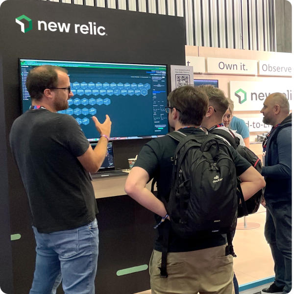 Group of people interacting with the New Relic booth