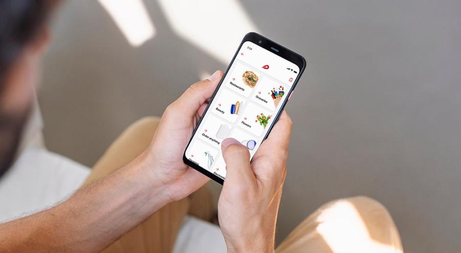 person looks at Delivery Hero app on mobile