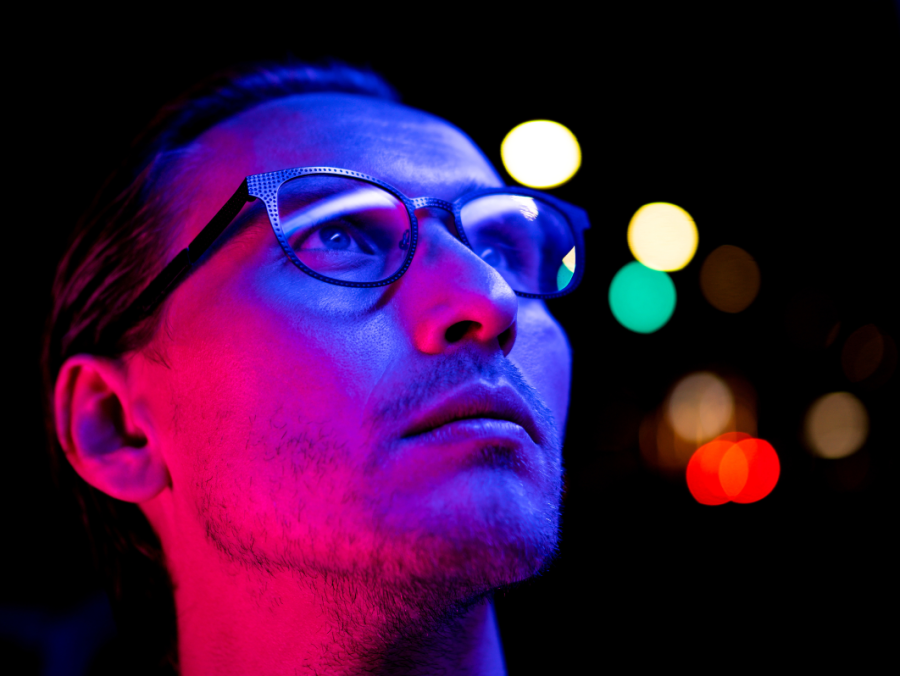 Man with glasses looking up