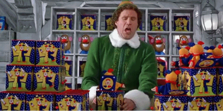Will Ferrell as Buddy the Elf reacting with a flinched expression while testing jack-in-the-boxes.